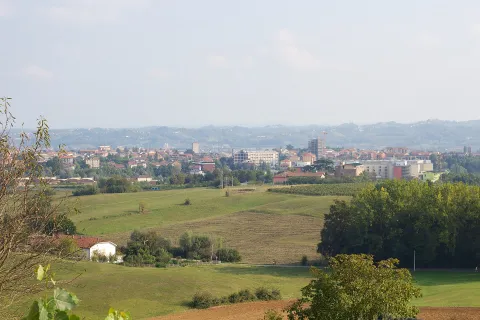 Panoramic view of rolling hills with the town of Asti in the background