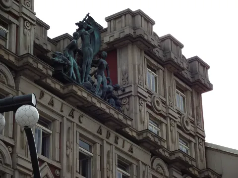 Facade of the Adria Palace in Prague featuring sculptures and rondocubist architectural details