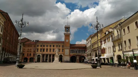 Piazza Vittorio Emanuele II in Rovigo featuring the central clock tower and historic buildings.