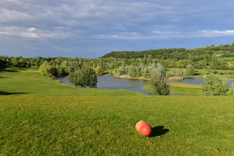 Golf course with a lake and hills in the countryside of Castel San Pietro Terme