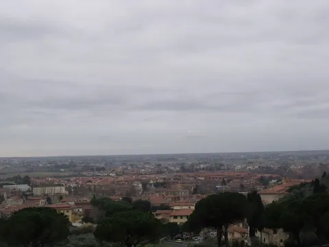Panoramic view of San Giuliano Terme and the surrounding plain under a cloudy sky
