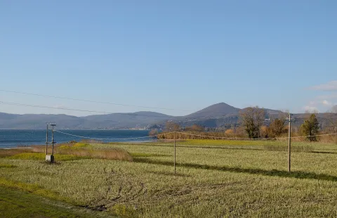 Agricultural fields surrounding Bracciano with a view of Lake Bracciano and distant hills.