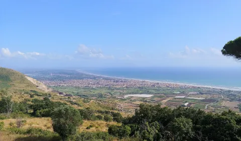 Panoramic view of Mondragone, its coastline, and surrounding plain from the hills