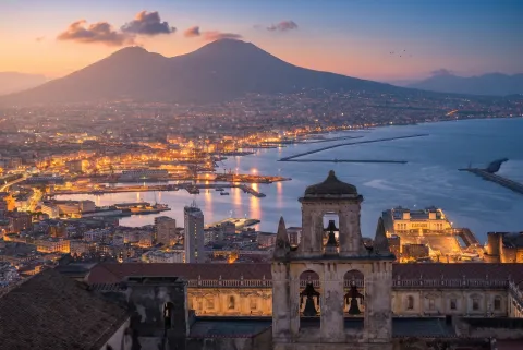Panoramic view of the city and bay of Naples at sunset with Mount Vesuvius in the background