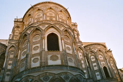 Intricate Arab-Norman exterior apse of Monreale Cathedral in Monreale, Italy.