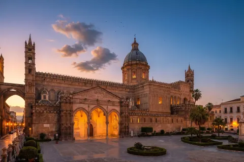 Palermo Cathedral illuminated at dusk with its surrounding plaza