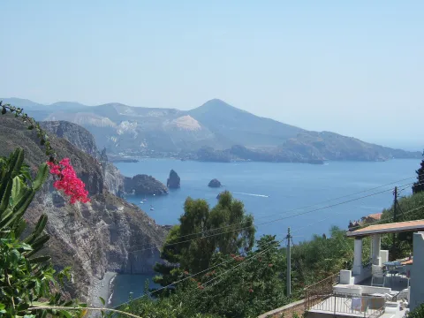 Panoramic view from Belvedere Quattrocchi on Lipari showing sea stacks and Vulcano island.