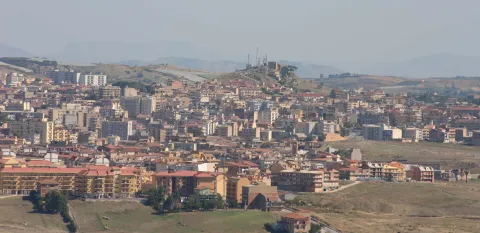 Panoramic view of the town of Canicattì with its buildings and surrounding hills in Sicily.