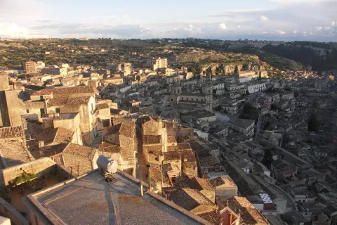 Country road winding through dry hills in the surroundings of Modica, Sicily