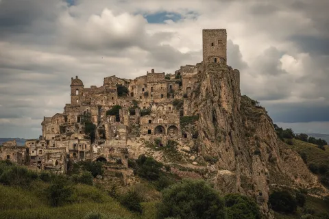 Panoramic view of Craco, the ghost town perched on a rocky cliff in Italy.