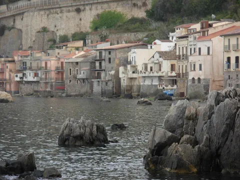 Coastal view of Chianalea in Scilla with traditional houses built right on the water and rocks.