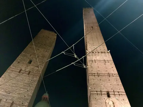 Low-angle night view looking up at the Two Towers of Bologna, Asinelli and Garisenda.
