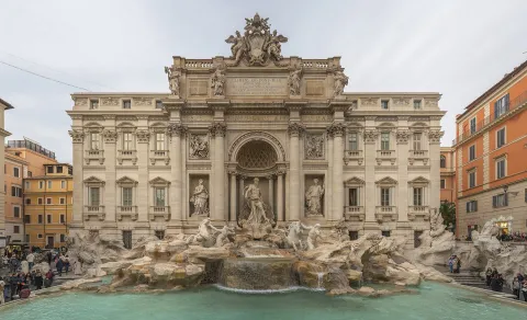 The grand Trevi Fountain in Rome featuring baroque sculptures and clear water.