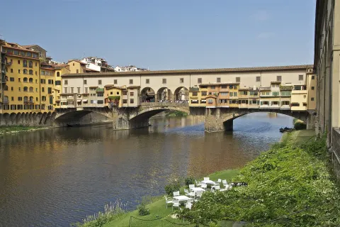 View of the iconic Ponte Vecchio bridge over the Arno River in Florence