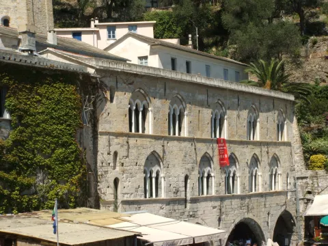 Stone facade of San Fruttuoso Abbey in Camogli with Gothic mullioned windows