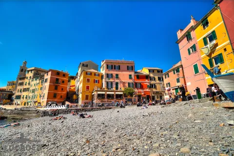 Pebble beach and colorful houses in the seaside village of Boccadasse in Genoa.