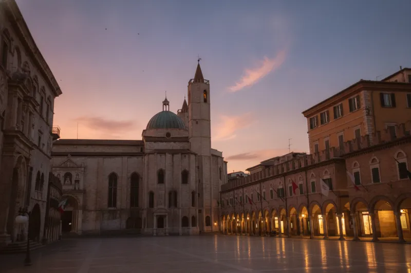 Piazza del Popolo in Ascoli Piceno featuring the Church of San Francesco and travertine arcades.